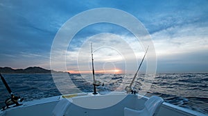 Sunrise view of fishing rod on charter fishing boat on the Pacific side of Cabo San Lucas in Baja California Mexico