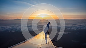 Sunrise view out of an airplane window. Plane flying over the clouds