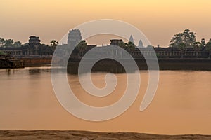 Sunrise view of popular tourist attraction ancient temple complex Angkor Wat with reflected in lake Siem Reap, Cambodia