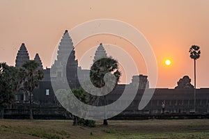 Sunrise view of popular tourist attraction ancient temple complex Angkor Wat with reflected in lake Siem Reap, Cambodia