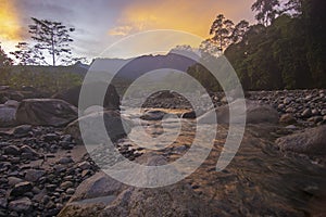 Sunrise view of a river with majestic Mount Kinabalu at background