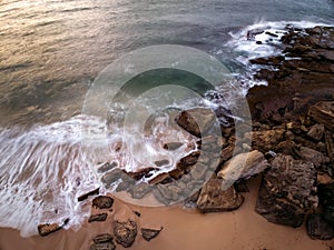 Sunrise views over the beach, sea and rocks