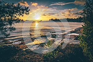 Sunrise in Vita Sandar bay, sandy beach with rocks in sweden