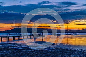 Sunrise waterscape with boats and clouds