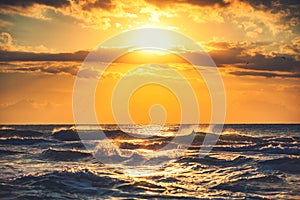 Beautiful cloudscape over the golden sunrise sea wave