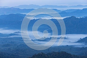 Sunrise white fog in early morning over high angle view of layer tropical mountains