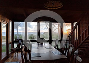 Sunrise into window of beachfront Waimanalo Beach house dinning room