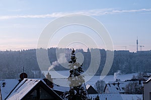 Sunrise on a winter morning over snow covered houses