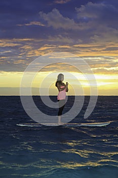 Sunrise yoga on paddle board