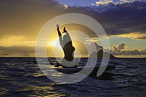 Sunrise yoga on paddle board