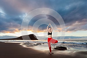 Sunrise yoga session on beach photo