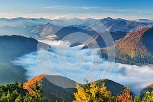Sunrise from Zadny Sip mountain during autumn with inversion mist in the valley