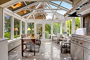 Sunroom patio area with transparent vaulted ceiling