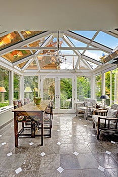 Sunroom patio area with transparent vaulted ceiling