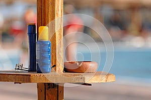 Sunscreen and ashtray at pool photo