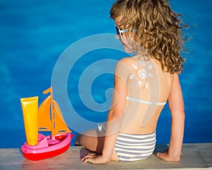 Sunscreen lotion sun drawing on childrens back