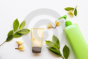 Sunscreen spf50  cosmetics health care for skin face, body lotion and yellow flowers frangipani