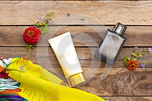 Sunscreen spf50  cosmetics health care for skin face with purfume ,yellow scarf and flowers of lifestyle