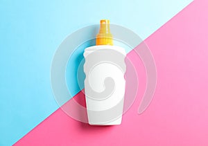 Sunscreen spray on two tone background