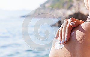 Sunscreen on a woman`s shoulder.