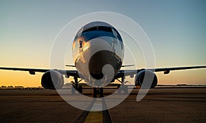 Sunset with 737 aircraft sat on the tarmac apron ramp