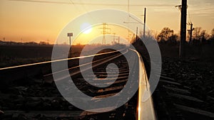 Sunset on abandoned rails on the outskirts of the city