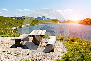 Sunset above the bench at the shore of the lake