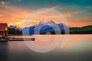 Sunset above boat house and Maligne Lake in Jasper National Park, Canada