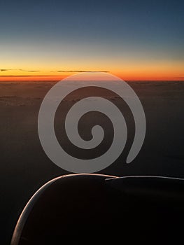 Sunset above clouds from an airplane