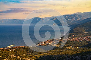 Sunset above coastal village of Cala Gonone and Tyrrhenian Sea in Sardinia