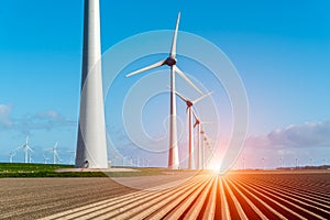 Sunset above windmills on the field