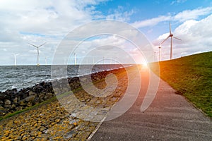 Sunset above windmills in the ocean