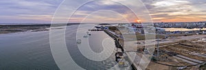 Sunset aerial panoramic seascape view of Olhao dockyard, waterfront to Ria Formosa natural park