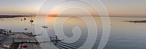 Sunset aerial panoramic seascape view of Olhao dockyard, waterfront to Ria Formosa natural park