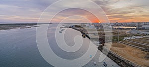 Sunset aerial panoramic seascape view of Olhao dockyard, waterfront to Ria Formosa natural park