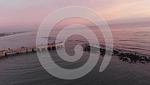 Sunset aerial pov vew to approch to pedestian jetty at Rome beach in Ostia Lido