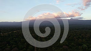 Sunset aerial view of forest, Kilimanjaro mountains on horizon, clouds in sky Tanzania Arusha Africa 5k Drone