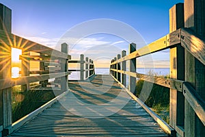 Sunset along the beach with a view over the dunes at a viewpoint with a sunburst