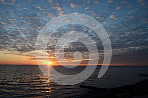 Sunset and altocumulus clouds over the sea