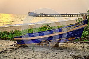 Sunset at anchor fishing boat at low tide