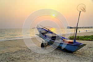 Sunset at anchor fishing boat at low tide