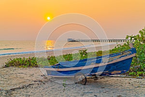 Sunset at anchor fishing boat at low tide