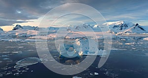 Sunset Antarctic iceberg floating in icy ocean