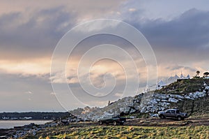 Sunset in the area of Punta Ballena, with a cloudy sky and Casa Pueblo in the background