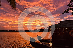 Sunset at Ashtamudi lake in Kollam, Kerala, India. Gorgeous summer time golden hour photo