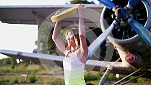 At sunset, athletic, young woman in sunglasses, in tights, doing exercises with weight, heavy weight plate, on an