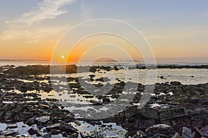 Sunset Atlantic Ocean view at Dar Bouazza beach, in Tamarist,