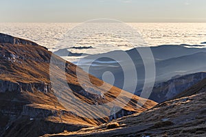 Sunset in the autumn alpine mountains, above the clouds, sea of clouds, Carpathians