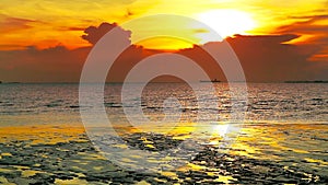 Sunset back dark cloud over sea and silhouette cargo ship parking on skyline