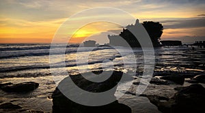 Sunset at Bali`s famous Tanah Lot temple, Indonesia.